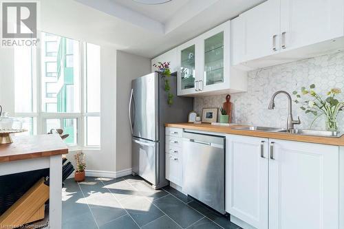 Professionally designed kitchen with Anatolia Vermont Graphite 12-inch x 24-inch Rectified Porcelain floor tiles.  Enough space to tuck in a table and chairs to make it an eat-in-kitchen. - 4450 Tucana Court Unit# 1010, Mississauga, ON - Indoor Photo Showing Kitchen With Double Sink