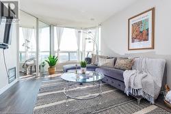 Living room bright and spacious with FULL unobstructed views of the city. Twinkles at night and sun-drenched in the daytime. - 