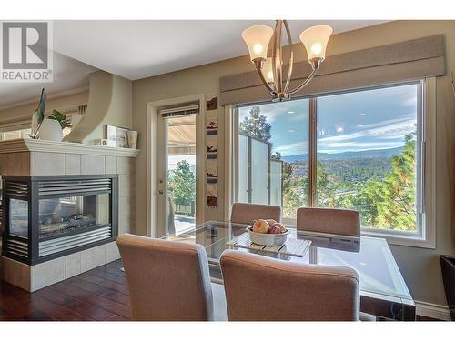 580 Denali Drive, Kelowna, BC - Indoor Photo Showing Dining Room With Fireplace