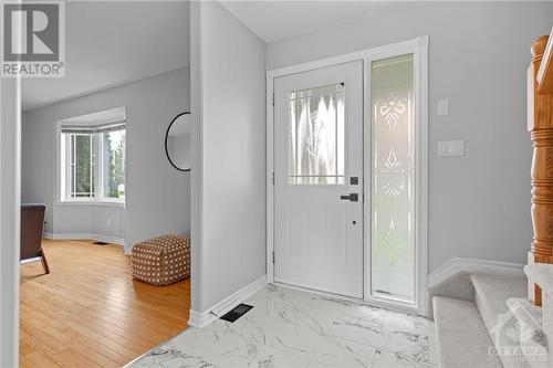 Welcoming entry way with upgraded tile (2023) and brand new carpet on stairs leading to the second level - 70 Lachaine Street, Embrun, ON - Indoor Photo Showing Other Room