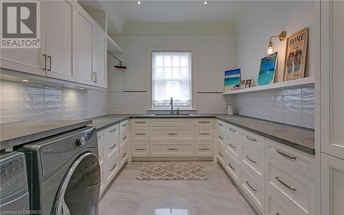 A laundry room with SO much organizational storage! - 27 Park Avenue, Oakville, ON - Indoor Photo Showing Laundry Room