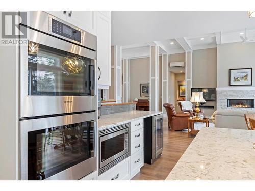 7255 Dunwaters Road, Kelowna, BC - Indoor Photo Showing Kitchen With Fireplace