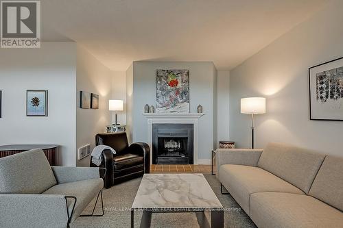 1003 - 700 Dynes Road, Burlington, ON - Indoor Photo Showing Living Room With Fireplace