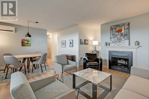 1003 - 700 Dynes Road, Burlington, ON - Indoor Photo Showing Living Room With Fireplace