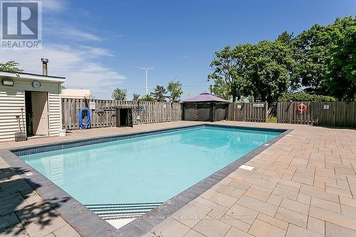 1003 - 700 Dynes Road, Burlington, ON - Outdoor With In Ground Pool