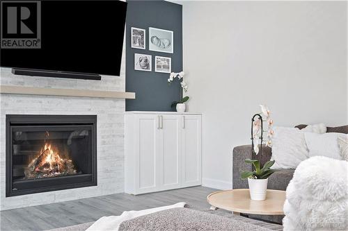 The centerpiece of this room is a stunning stone fireplace that exudes warmth and sophistication. Designed with modern living in mind, the fireplace is TV-ready, with pre-wired connections making - 708 Geneva Crescent, Embrun, ON - Indoor Photo Showing Living Room With Fireplace