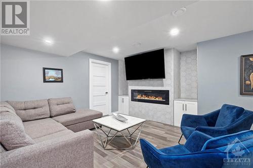 The professionally finished basement is a true extension of the home's elegance and functionality. Designed with the same attention to detail as the rest of the house, this space offers a warm and - 708 Geneva Crescent, Embrun, ON - Indoor Photo Showing Living Room With Fireplace