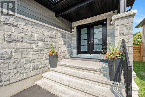 As you approach the home, the beautifully crafted stone façade immediately captures your attention, exuding both strength and sophistication. The grand double entry door serves as a magnificent fo - 708 Geneva Crescent, Embrun, ON - Outdoor