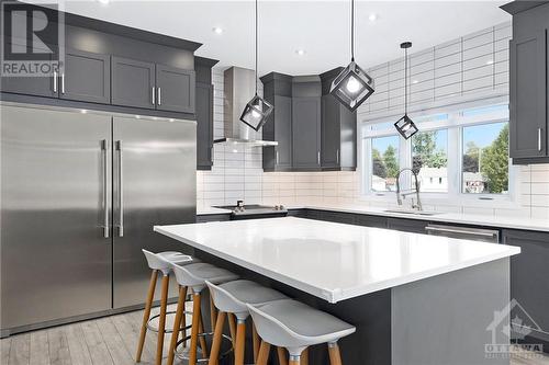 The heart of this home is its breathtaking gourmet kitchen, where no detail has been overlooked. At its center is a stunning quartz island. This elegant centerpiece is complemented by a tile backs - 708 Geneva Crescent, Embrun, ON - Indoor Photo Showing Kitchen With Upgraded Kitchen