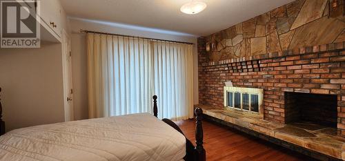 1912 Third  Avenue, Trail, BC - Indoor Photo Showing Bedroom With Fireplace