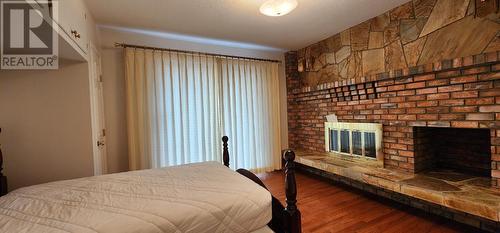 1912 Third  Avenue, Trail, BC - Indoor Photo Showing Bedroom With Fireplace