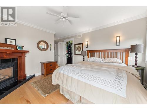 9732 Cameron Road, Vernon, BC - Indoor Photo Showing Bedroom With Fireplace