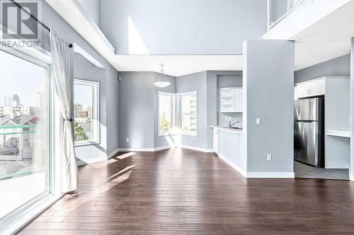 Rich brown engineered hardwood flooring on the main floor - 1203, 1514 11 Street Sw, Calgary, AB - Indoor Photo Showing Other Room