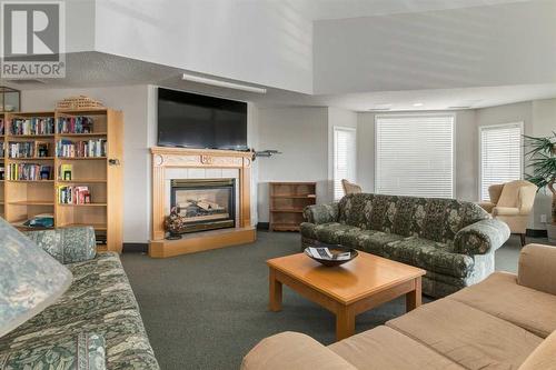 3309, 3000 Sienna Park Green Sw, Calgary, AB - Indoor Photo Showing Living Room With Fireplace