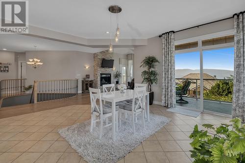 1003 Skeena Drive, Kelowna, BC - Indoor Photo Showing Dining Room With Fireplace