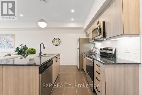 506 - 4 Spice Way, Barrie, ON - Indoor Photo Showing Kitchen With Stainless Steel Kitchen With Double Sink With Upgraded Kitchen