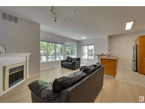 #234 10023 110 St Nw, Edmonton, AB - Indoor Photo Showing Living Room With Fireplace