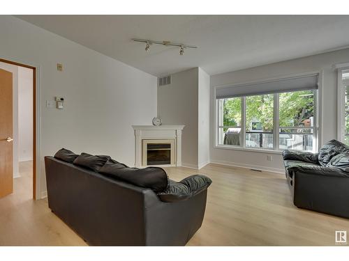 #234 10023 110 St Nw, Edmonton, AB - Indoor Photo Showing Living Room With Fireplace