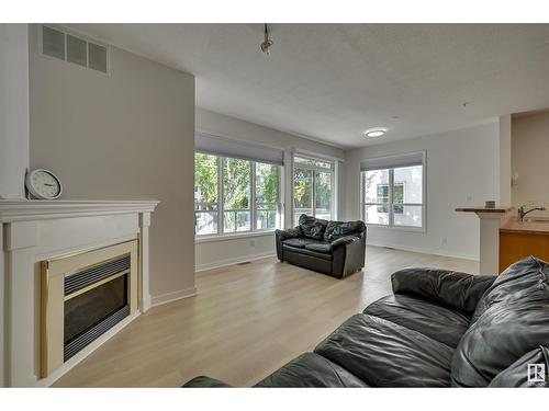 #234 10023 110 St Nw, Edmonton, AB - Indoor Photo Showing Living Room With Fireplace