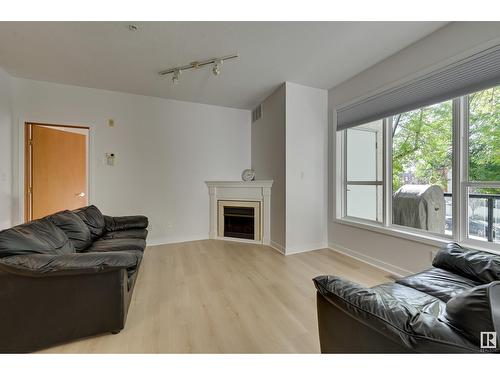 #234 10023 110 St Nw, Edmonton, AB - Indoor Photo Showing Living Room With Fireplace