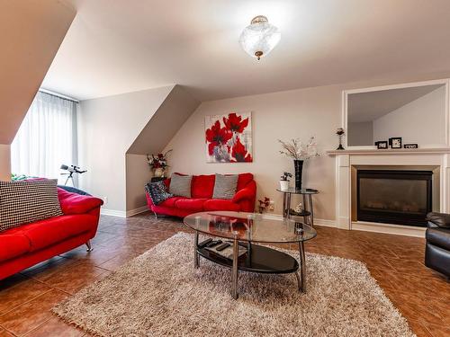 Family room - 12325 Rue Maurice-Séguin, Montréal (Rivière-Des-Prairies/Pointe-Aux-Trembles), QC - Indoor Photo Showing Living Room With Fireplace