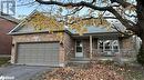 View of front of home with a garage and covered porch - 1358 Bobolink Court, Peterborough, ON  - Outdoor With Deck Patio Veranda 