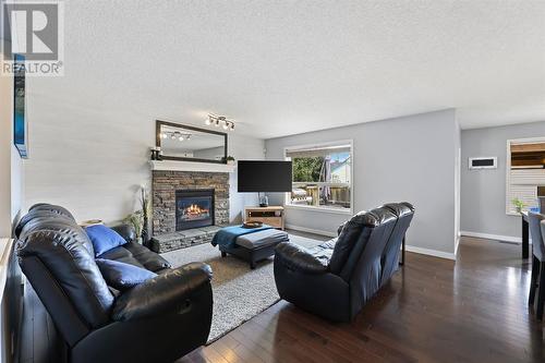 133 Prestwick Mews Se, Calgary, AB - Indoor Photo Showing Living Room With Fireplace