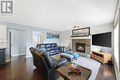 133 Prestwick Mews Se, Calgary, AB - Indoor Photo Showing Living Room With Fireplace