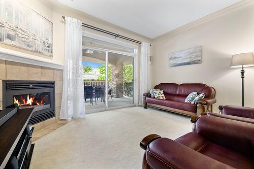 106-1964 Enterprise Way, Kelowna, BC - Indoor Photo Showing Living Room With Fireplace