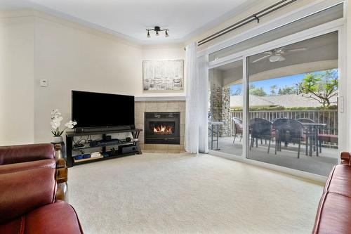 106-1964 Enterprise Way, Kelowna, BC - Indoor Photo Showing Living Room With Fireplace