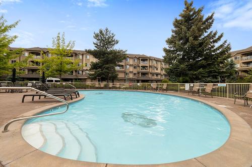 106-1964 Enterprise Way, Kelowna, BC - Outdoor With In Ground Pool With Backyard