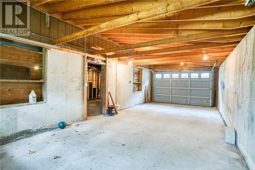 One of many lower level garage bay doors ... - 1215 Narrows Lock Road, Portland, ON - Indoor Photo Showing Basement