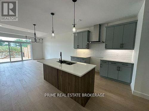 50 - 12 Coastal Crescent, Lambton Shores (Grand Bend), ON - Indoor Photo Showing Kitchen With Double Sink