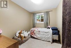 Carpeted bedroom featuring vaulted ceiling - 