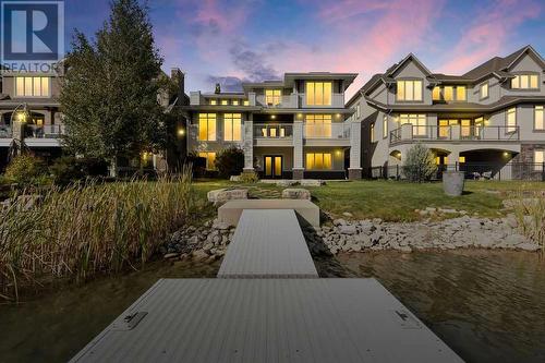 111 Mahogany Bay Se, Calgary, AB - Outdoor With Body Of Water With Deck Patio Veranda With Facade