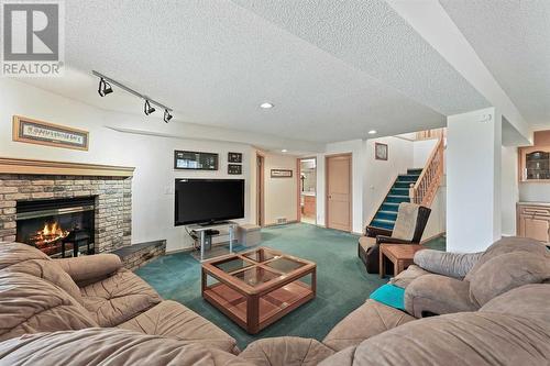 181 Hamptons Green Nw, Calgary, AB - Indoor Photo Showing Living Room With Fireplace