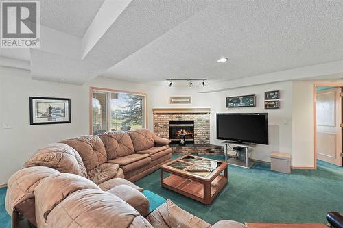 181 Hamptons Green Nw, Calgary, AB - Indoor Photo Showing Living Room With Fireplace