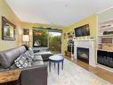 105-90 Regatta Landing, Victoria, BC  - Indoor Photo Showing Living Room With Fireplace 