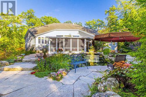 Epic Landscaping past the Strictly Sunrooms add-on - 9984 The Trail Trail, Lambton Shores (Grand Bend), ON - Outdoor With Deck Patio Veranda