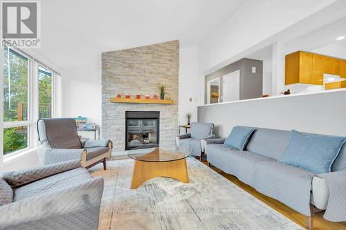 1018C Leisure Lane, North Frontenac, ON - Indoor Photo Showing Living Room With Fireplace