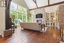 The impressive great room showcasing 28’ cathedral ceilings; a wall of windows with remote controlled window coverings; an oversized gas fireplace; and spruce trusses imported from Austria. - 165 Adrien Street, Clarence-Rockland, ON  - Indoor Photo Showing Other Room With Fireplace 