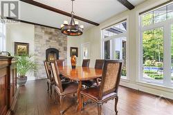 The formal dining room has French door access, and is bathed in sunlight thanks to the two walls of windows, a cozy gas burning fireplace, antique wood plank ceilings and imported spruce trusses a - 