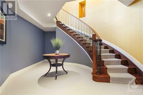 A graceful circular staircase leads down to the professionally finished basement - 165 Adrien Street, Clarence-Rockland, ON - Indoor Photo Showing Other Room