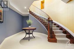 A graceful circular staircase leads down to the professionally finished basement - 