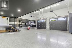 The oversized heated garage provides ample space for a workshop and additional ‘loft’ storage, making it a true man-cave. - 