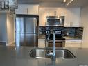 207 5301 Universal Crescent, Regina, SK  - Indoor Photo Showing Kitchen With Stainless Steel Kitchen With Double Sink 