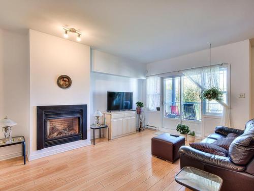 Living room - 63-12585 Rue Forsyth, Montréal (Rivière-Des-Prairies/Pointe-Aux-Trembles), QC - Indoor Photo Showing Living Room With Fireplace