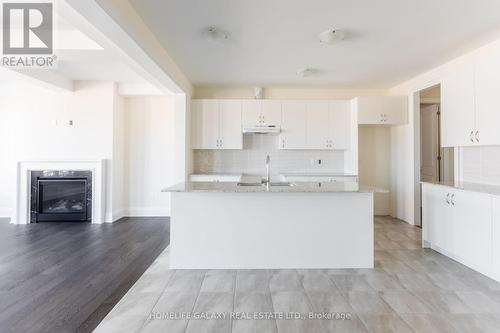 26 Autumn Frost Road, Otonabee-South Monaghan, ON - Indoor Photo Showing Kitchen With Fireplace