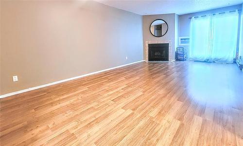 303 1683 Plessis Road, Winnipeg, MB - Indoor Photo Showing Other Room With Fireplace