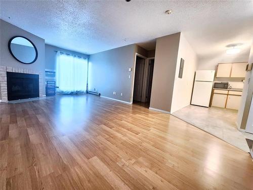 303 1683 Plessis Road, Winnipeg, MB - Indoor Photo Showing Other Room With Fireplace